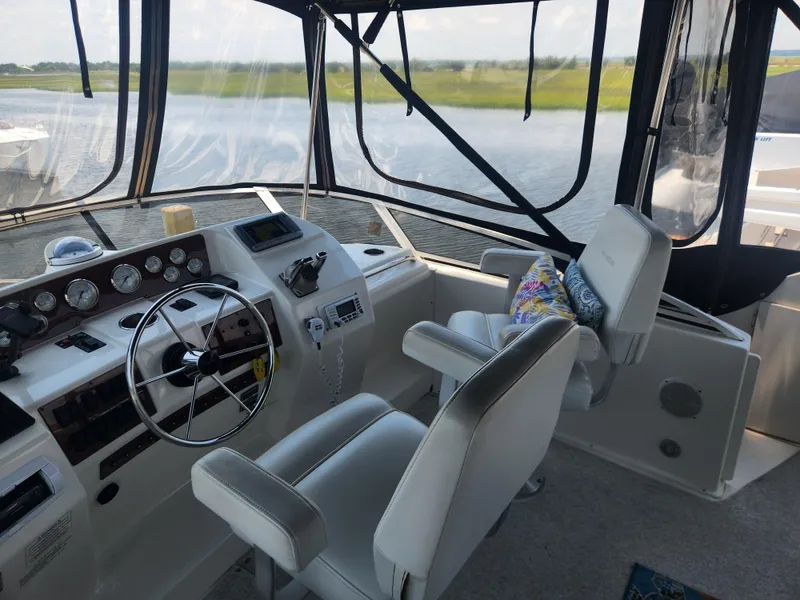 Slide: The Image of Interior view of 2000 Silverton 453 Motor Yacht helm with steering wheel and controls. - 8