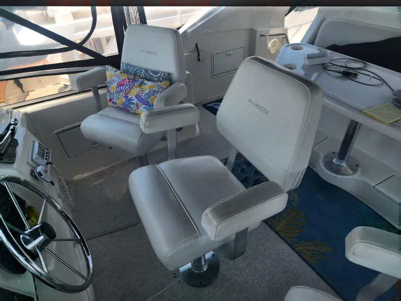 Slide: The Image of Interior of 2000 Silverton 453 Motor Yacht with plush seating and steering wheel. - 9