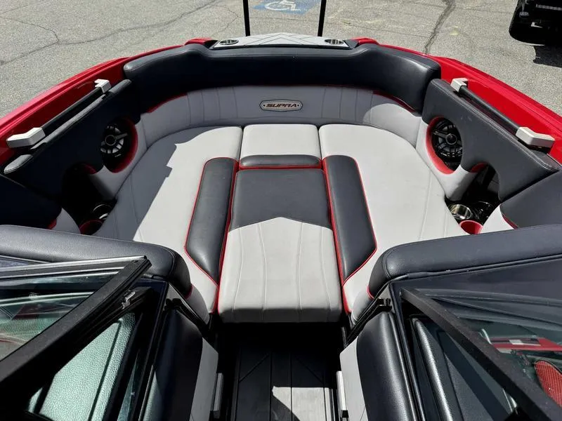 Slide: The Image of 2019 Supra SE550 boat interior with red and gray seating, featuring premium audio speakers. - 12