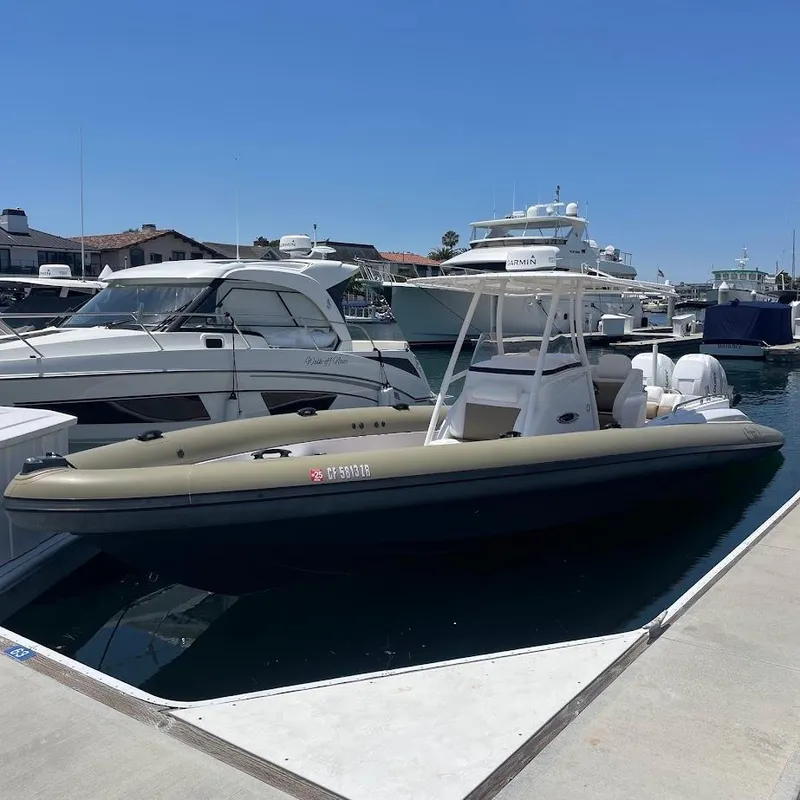 The Image of 2016 Airship 330 boat docked at marina, surrounded by other vessels under clear blue sky. - 1