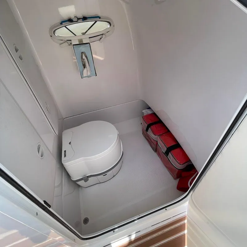 Slide: The Image of Compact bathroom in 2016 Airship 330, featuring a toilet and storage space. - 13