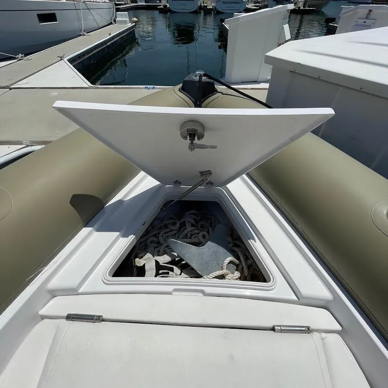 Slide: The Image of Open storage compartment on 2016 Airship 330 boat, revealing anchor and ropes. - 14