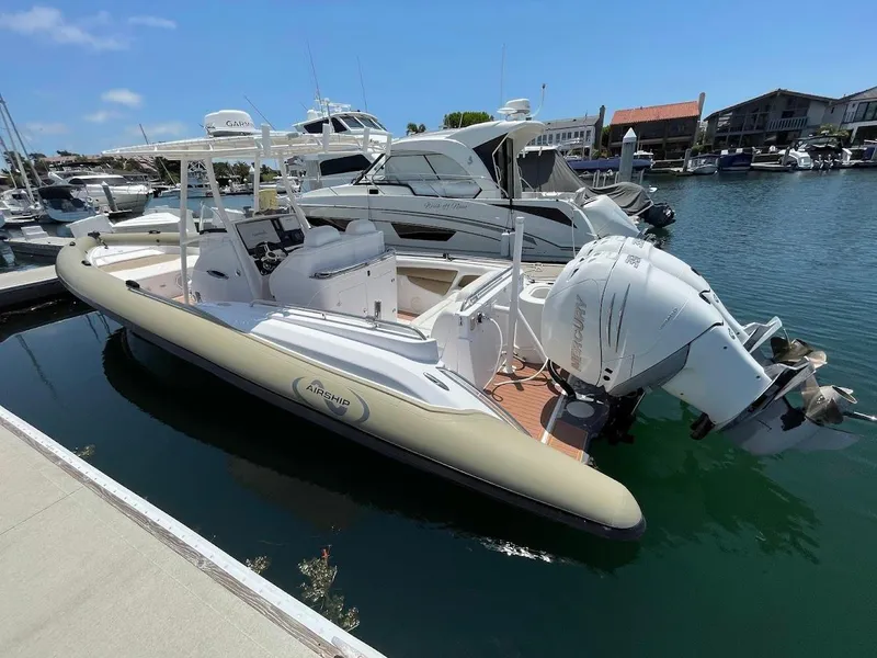 Slide: The Image of Airship 330 boat docked in marina, featuring Mercury outboard engine, 2016 model. - 17