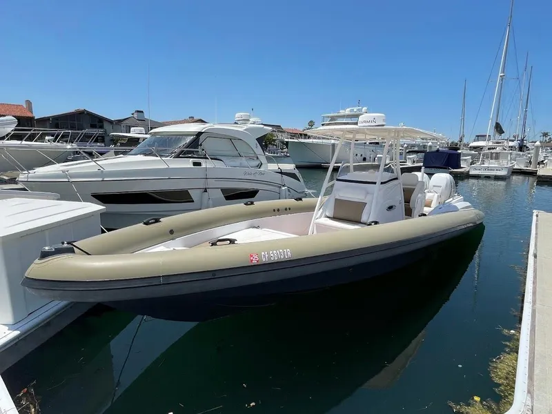 Slide: The Image of 2016 Airship 330 boat docked in marina, surrounded by other vessels under clear blue sky. - 18