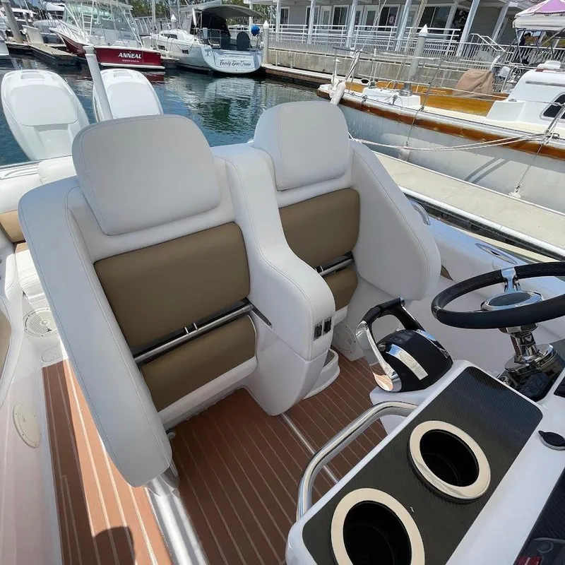 Slide: The Image of Luxury boat interior with white and brown seats, steering wheel, and cup holders. Airship 330, 2016. - 6