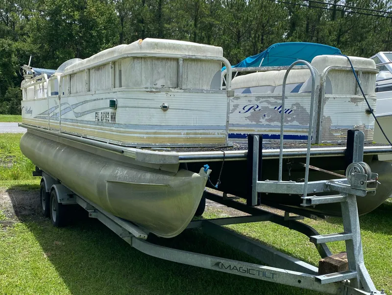 The Image of 2004 Bentley Pontoons 240 CRUISE on trailer, parked on grass, with trees in background. - 1