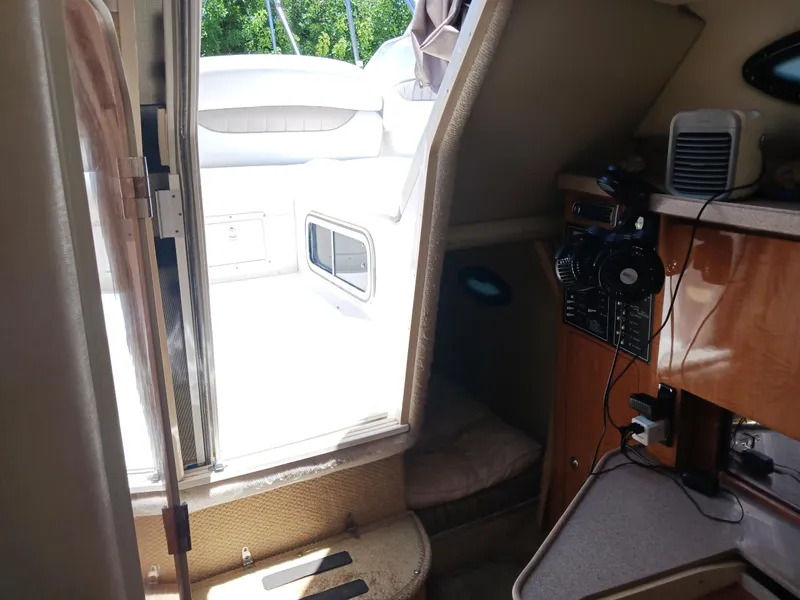 Slide: The Image of Interior view of 2004 Regal 2760 Commodore boat cabin with seating and control panel. - 14