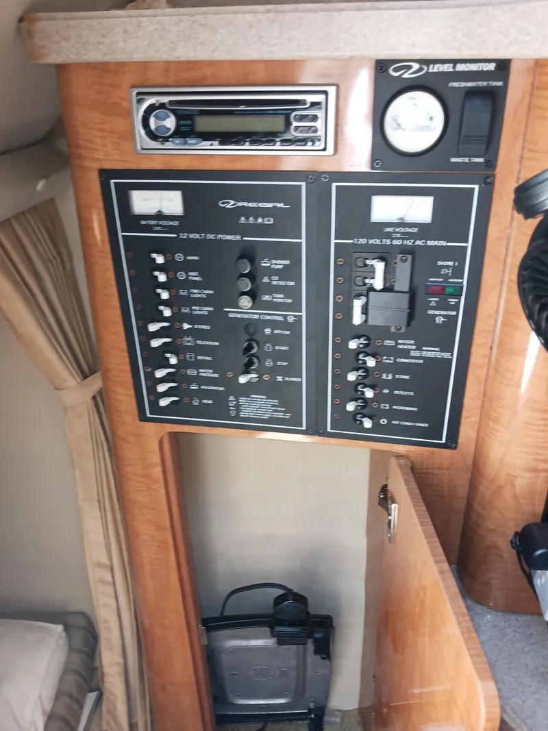 Slide: The Image of 2004 Regal 2760 Commodore control panel with switches and gauges in cabin interior. - 17