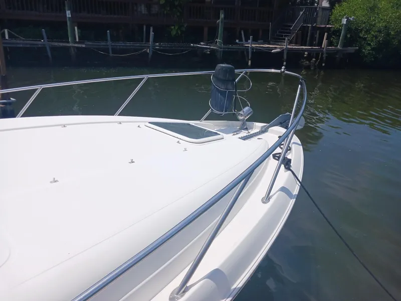 Slide: The Image of 2004 Regal 2760 Commodore boat docked by wooden pier. - 23