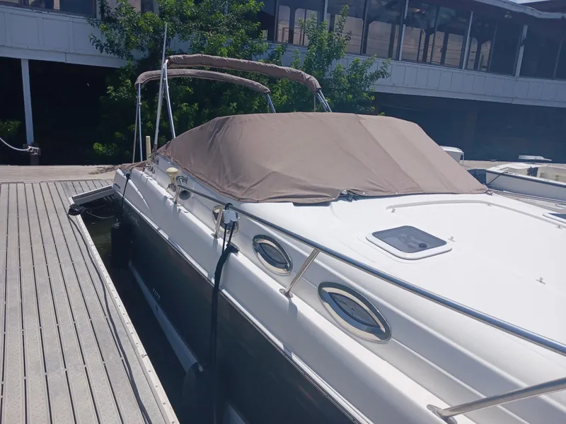 Slide: The Image of 2004 Regal 2760 Commodore boat docked with cover, side view. - 24