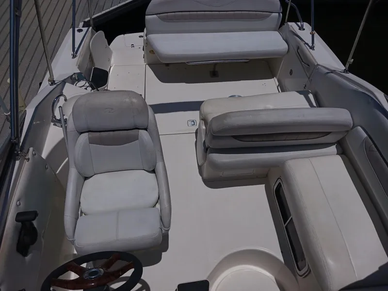 Slide: The Image of 2004 Regal 2760 Commodore boat interior with white seating and steering wheel. - 4