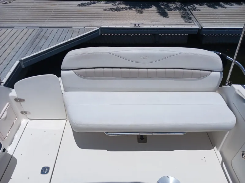 Slide: The Image of White seating area on a 2004 Regal 2760 Commodore boat at a dock. - 5