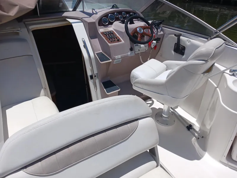 Slide: The Image of 2004 Regal 2760 Commodore boat interior with steering wheel and seating. - 7