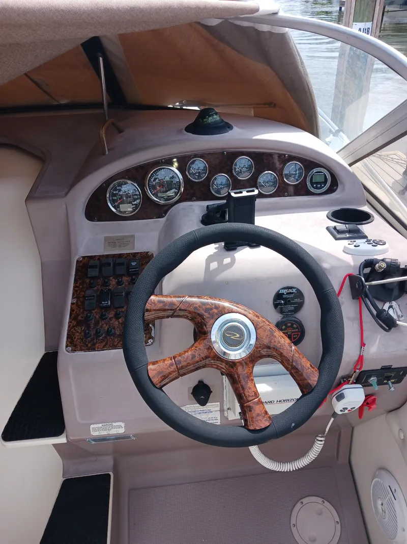 Slide: The Image of 2004 Regal 2760 Commodore boat dashboard with steering wheel and instrument panel. - 9