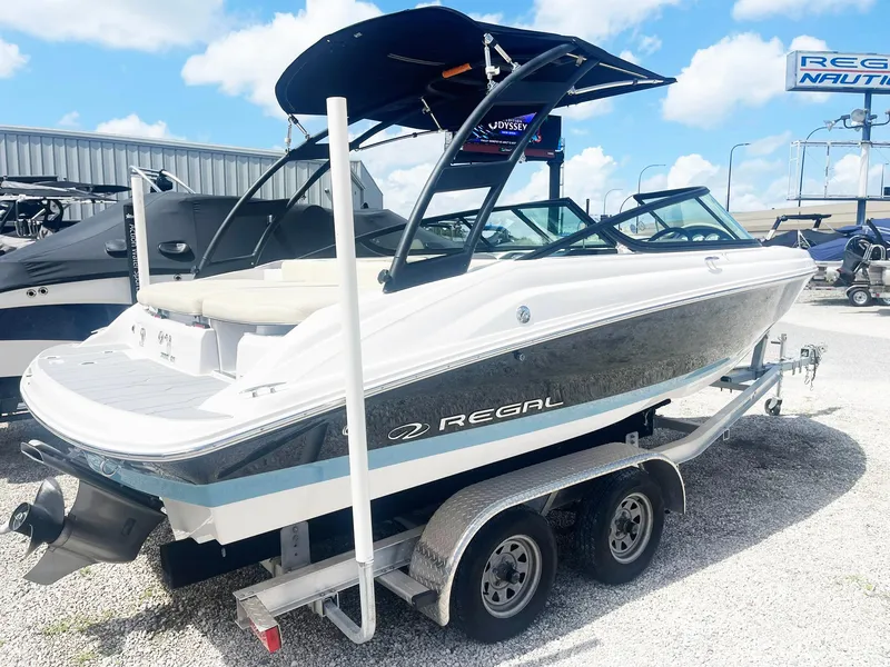 Slide: The Image of 2021 Regal 2000 ES Bowrider on trailer, displayed outdoors under blue sky. - 3