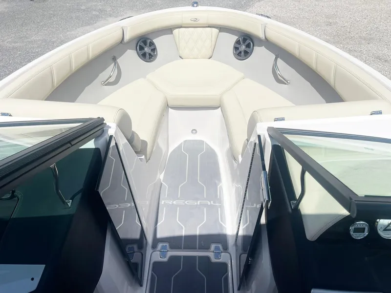 Slide: The Image of 2021 Regal 2000 ES Bowrider interior with beige seating and open windshield. - 7