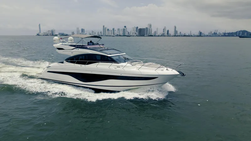 The Image of Luxurious 2020 Princess S62 yacht cruising near a city skyline. - 0