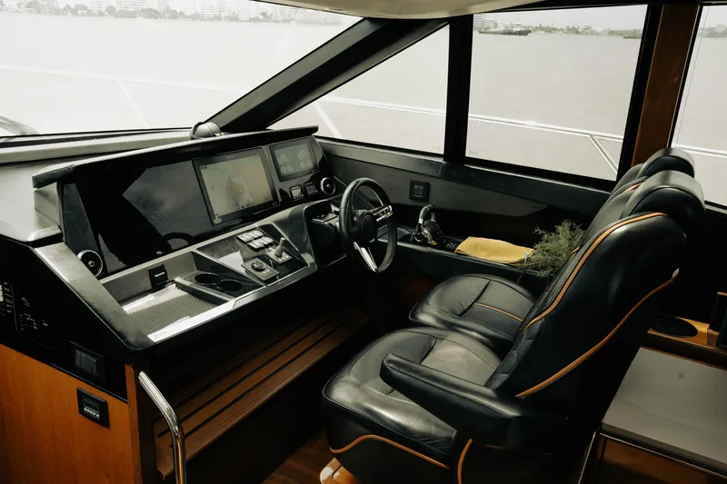 Slide: The Image of Luxurious 2020 Princess S62 yacht cockpit with modern navigation controls and leather seating. - 17