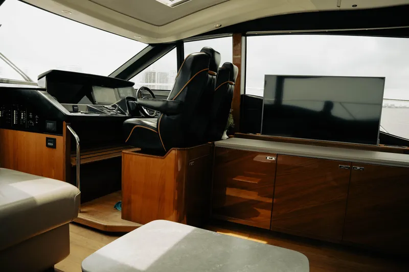 Slide: The Image of Interior of 2020 Princess S62 yacht with helm, leather seating, and wooden cabinetry. - 19