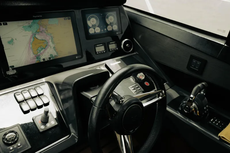 Slide: The Image of Control panel of a 2020 Princess S62 yacht with navigation screens and steering wheel. - 25