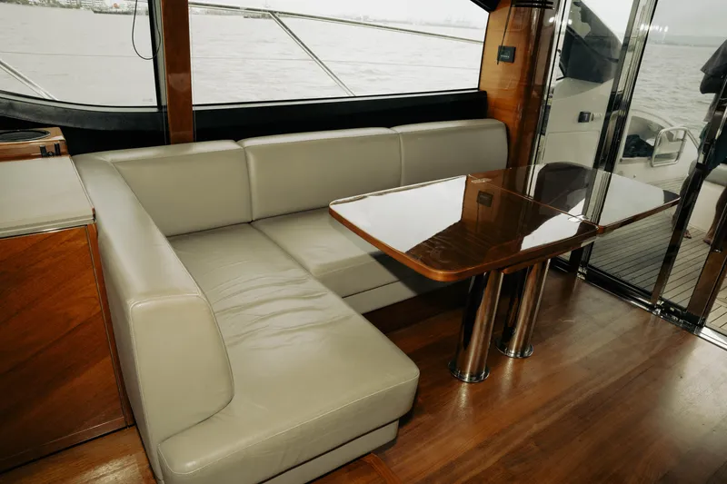 Slide: The Image of Luxurious interior of 2020 Princess S62 yacht with leather seating and wooden table. - 32