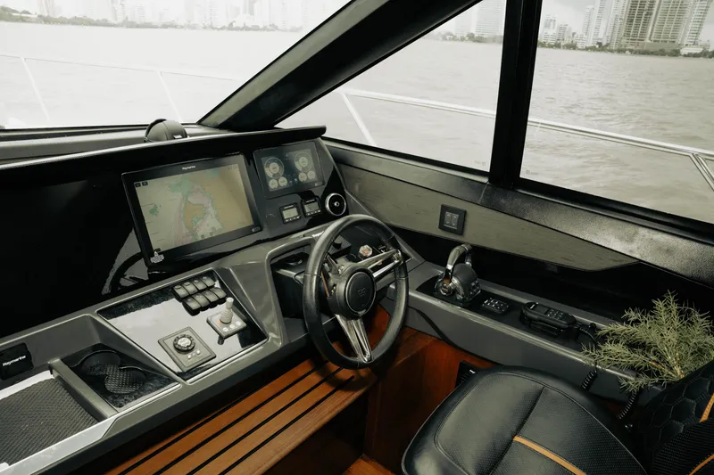 Slide: The Image of Helm of 2020 Princess S62 yacht with navigation screens and controls. - 33