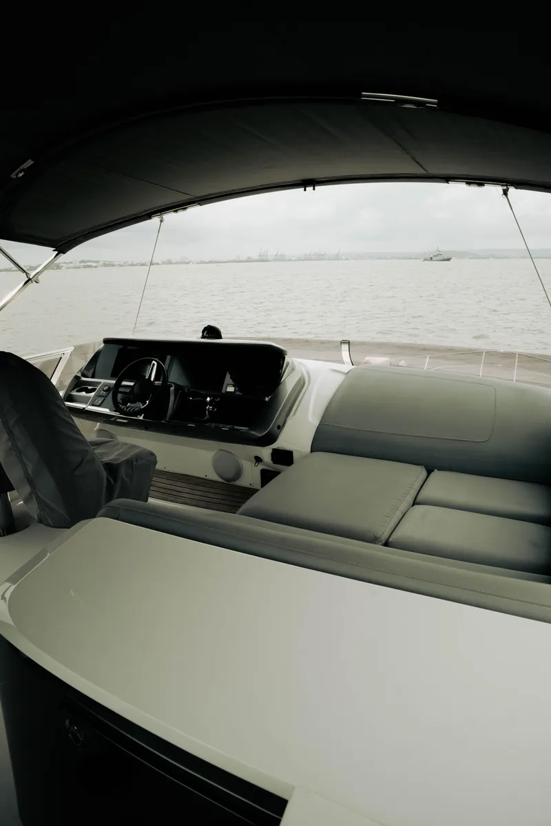 Slide: The Image of Luxurious 2020 Princess S62 yacht interior with sleek seating and modern helm, overlooking calm waters. - 41