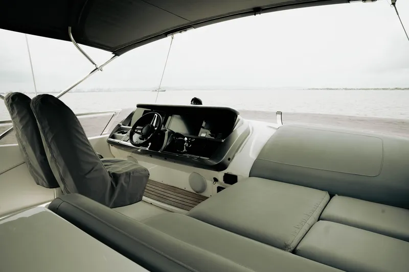 Slide: The Image of Luxurious 2020 Princess S62 yacht interior with helm and seating, overlooking calm waters. - 42