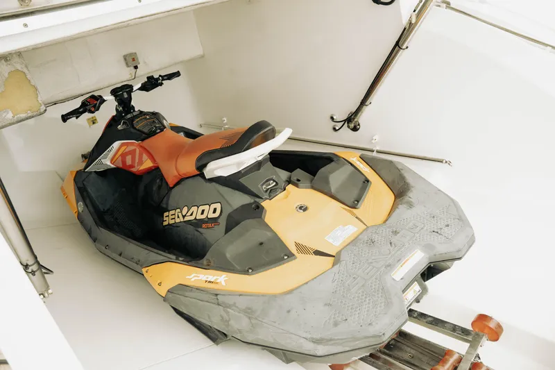 Slide: The Image of Orange Sea-Doo jet ski stored in a 2020 Princess S62 yacht compartment. - 45