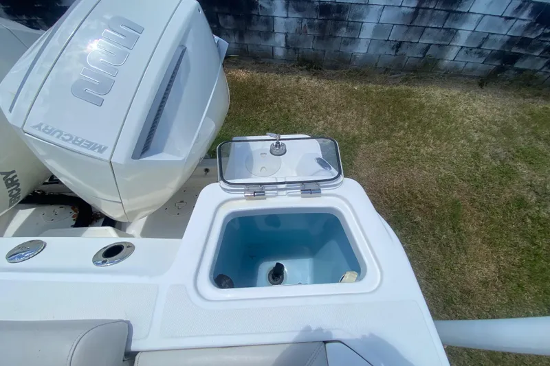 Slide: The Image of 2022 Boston Whaler 250 Outrage boat with Mercury engine and open livewell. - 11