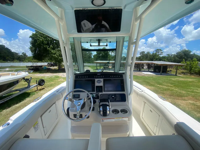 Slide: The Image of 2022 Boston Whaler 250 Outrage boat cockpit with steering wheel and control panel. - 12