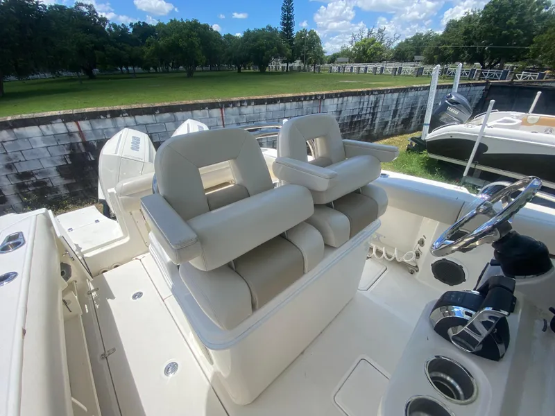 Slide: The Image of 2022 Boston Whaler 250 Outrage boat interior with dual helm seats and steering wheel. - 14