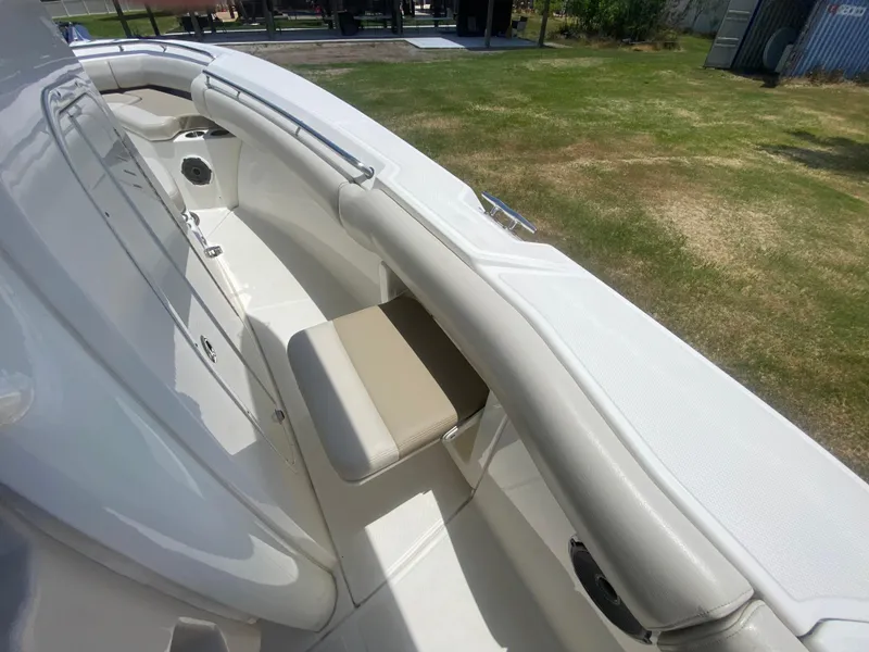 Slide: The Image of 2022 Boston Whaler 250 Outrage boat interior with cushioned seating and sleek design. - 16