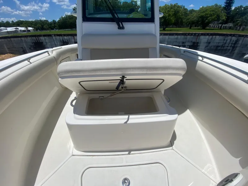 Slide: The Image of 2022 Boston Whaler 250 Outrage boat interior with open storage compartment. - 24