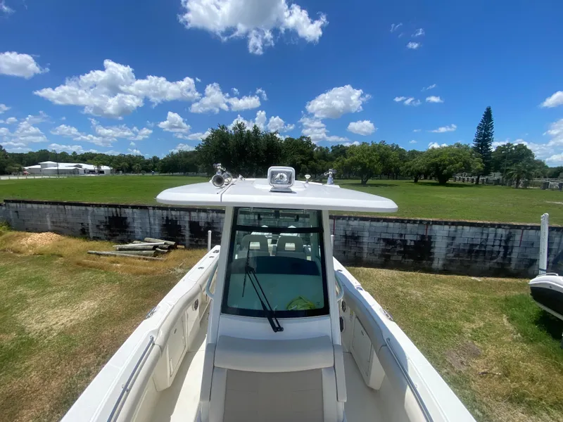 Slide: The Image of Boston Whaler 250 Outrage 2022 boat on land under a clear blue sky. - 26