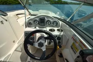 Slide: The Image of 2011 Sea Ray 240 Sundeck boat dashboard with steering wheel and gauges. - 15