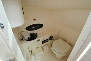 Slide: The Image of 2011 Sea Ray 240 Sundeck boat bathroom with sink and toilet. - 17