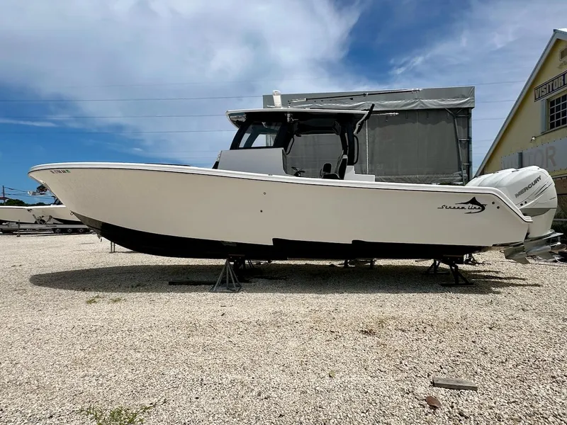 The Image of 2021 Streamline 35CC boat on display, white hull, outdoor setting, clear sky background. - 0