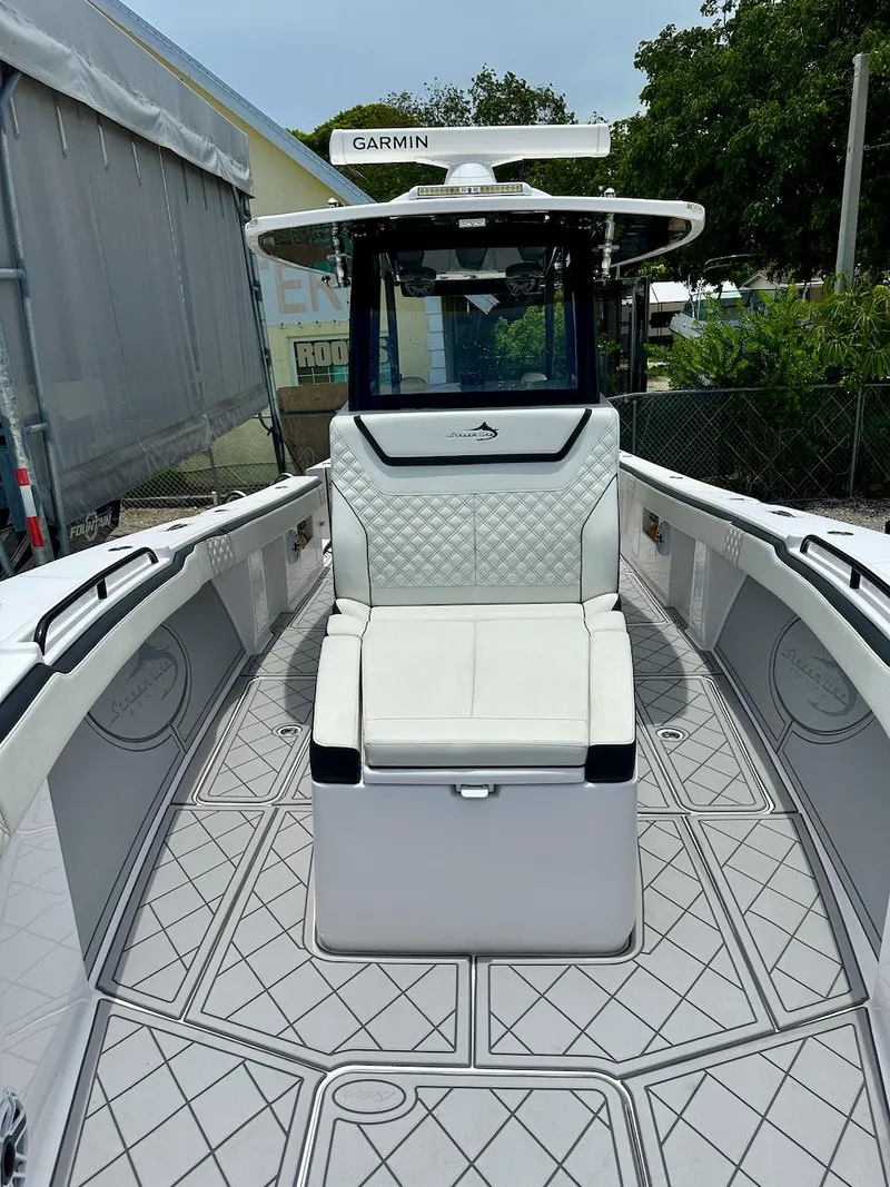 Slide: The Image of 2021 Streamline 35CC boat interior with cushioned seating and Garmin equipment. - 11