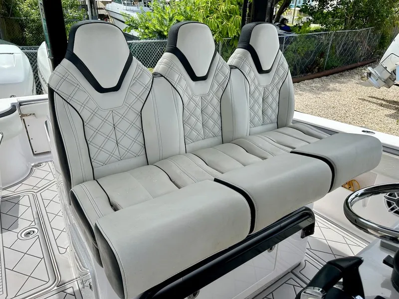 Slide: The Image of Luxurious seating on 2021 Streamline 35CC boat, featuring elegant white upholstery and modern design. - 13