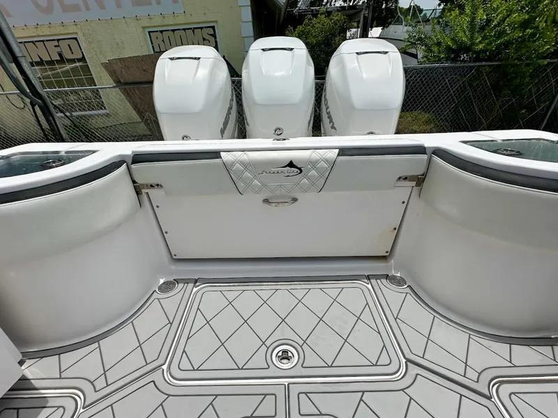 Slide: The Image of Streamline 35CC boat deck with triple outboard engines, 2021 model, featuring diamond-pattern flooring. - 26
