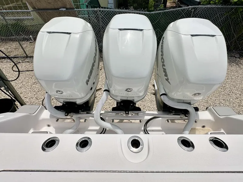 Slide: The Image of Three Mercury outboard engines on a 2021 Streamline 35CC boat, viewed from above. - 3