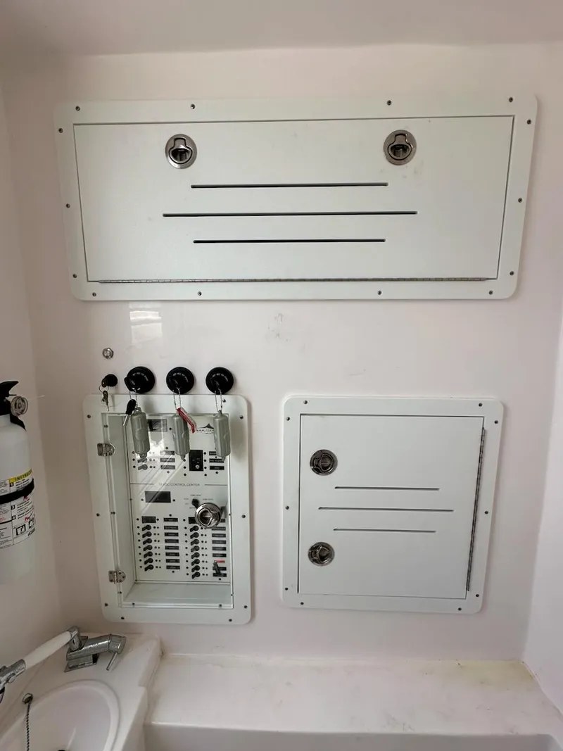 Slide: The Image of Control panel and storage compartments in a 2021 Streamline 35CC boat interior. - 31