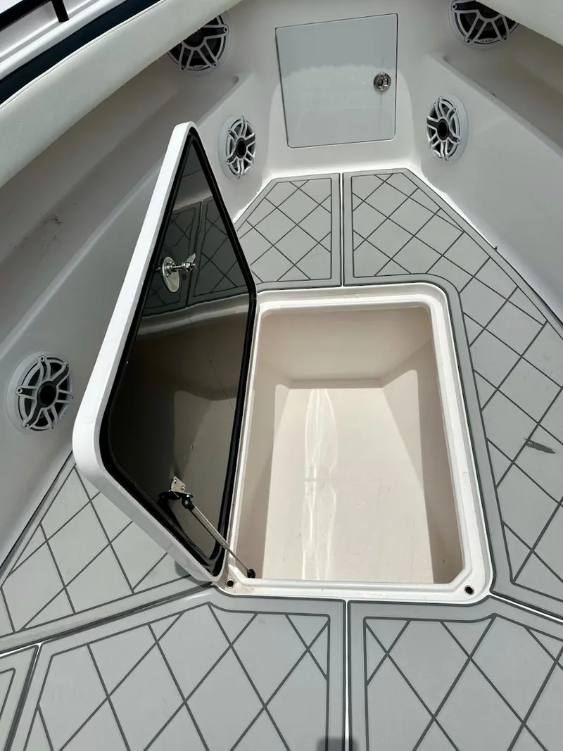 Slide: The Image of Open storage compartment on 2021 Streamline 35CC boat deck with geometric pattern. - 9