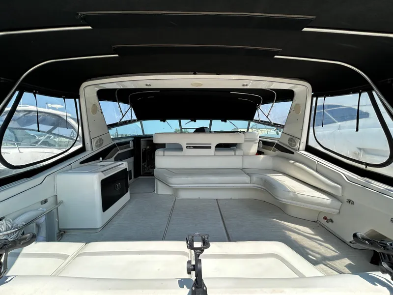 Slide: The Image of Interior of a 1993 Sea Ray 440 Sundancer yacht with white seating and modern design. - 12