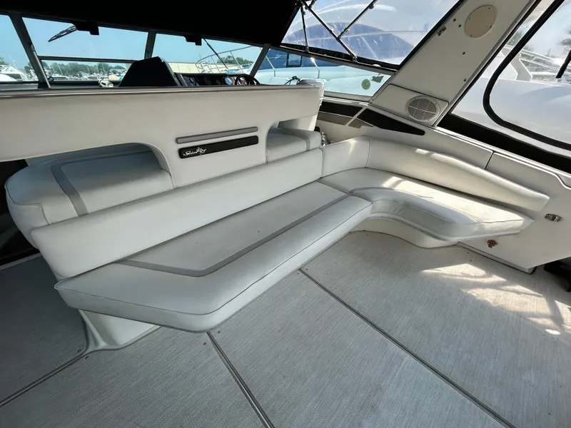 Slide: The Image of 1993 Sea Ray 440 Sundancer interior seating with logo, showcasing luxury design. - 19