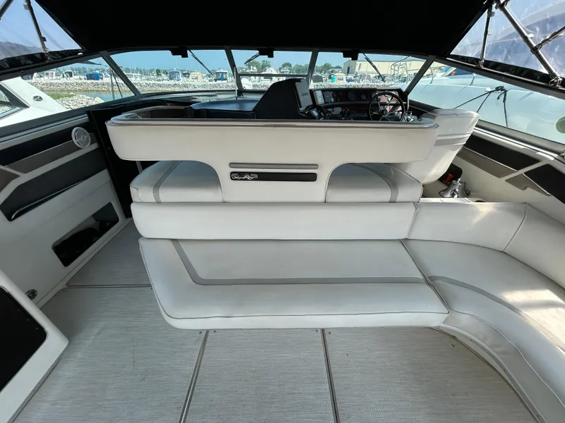 Slide: The Image of Interior of 1993 Sea Ray 440 Sundancer yacht with white seating and helm. - 21