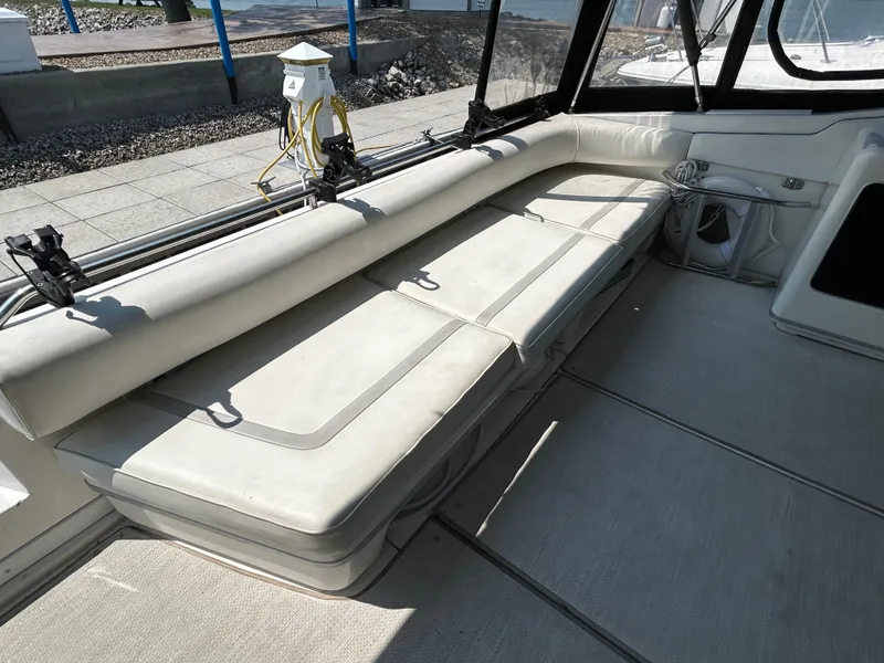 Slide: The Image of Interior view of 1993 Sea Ray 440 Sundancer yacht, featuring seating and cabin entrance. - 26