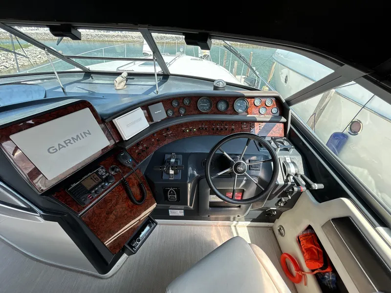 Slide: The Image of 1993 Sea Ray 440 Sundancer dashboard with Icom marine radio and microphone. - 35