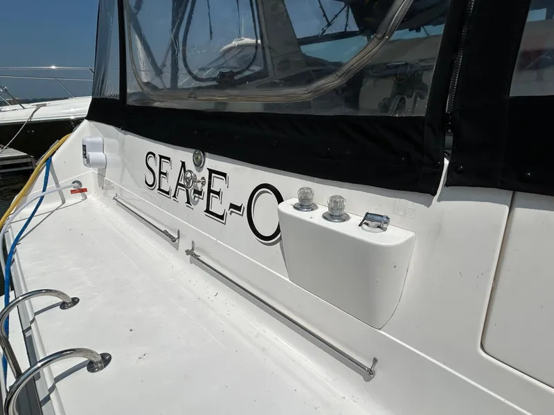 Slide: The Image of 1993 Sea Ray 440 Sundancer boat with "SEA-E-O" name on the side. - 4